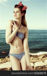 young woman with perfect body wearing bikini and vintage foulard in the long blonde hair, sensual pose, fashion shoot