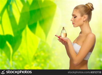 Young woman with perfume on floral spring background