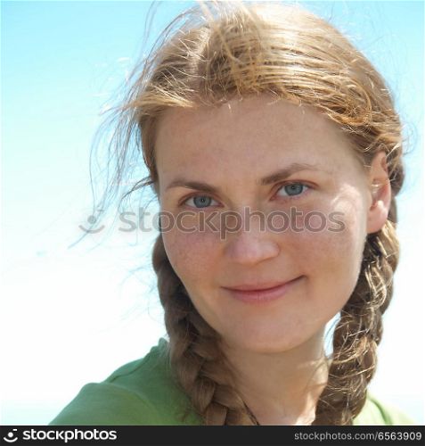 Young woman with pigtails. Young woman with pigtails, red hair and freckles