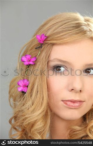 Young woman with pink flowers in her hair