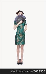 Young Woman with Qipao Covering Her Face with Fan