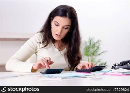 Young woman with receipts in budget planning concept 