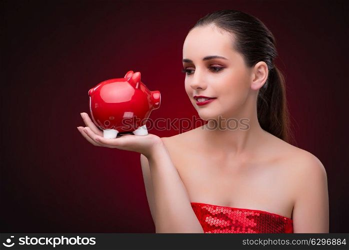 Young woman with red piggybank