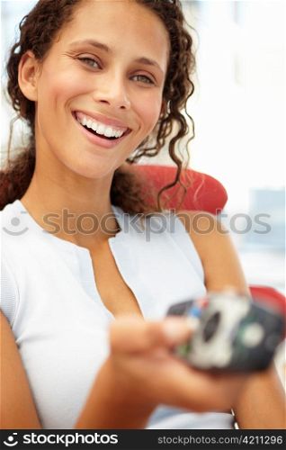 Young woman with remote control
