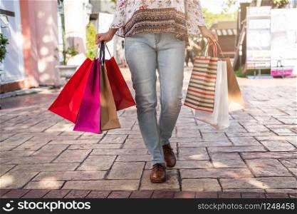 Young woman with shopping bags at shopping mall on black friday, Woman lifestyle concept