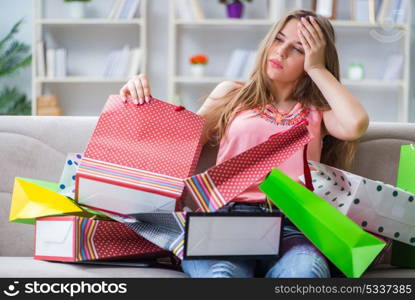 Young woman with shopping bags indoors home on sofa