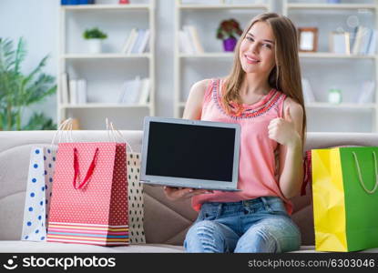 Young woman with shopping bags indoors home on sofa