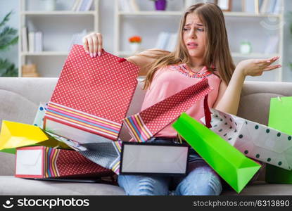 Young woman with shopping bags indoors home on sofa