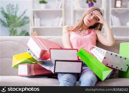 Young woman with shopping bags indoors home on sofa