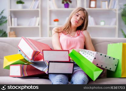 Young woman with shopping bags indoors home on sofa