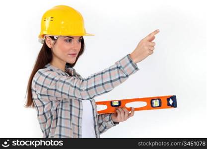 Young woman with spirit level
