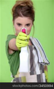 Young woman with spray cleaner