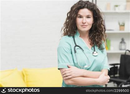 young woman with stethoscope around her neck standing hospital