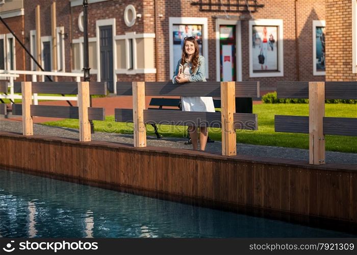 Young woman with tablet on bridge at Amsterdam