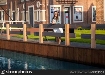 Young woman with tablet on bridge at Amsterdam