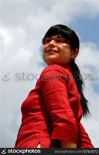 young woman with the sky as background
