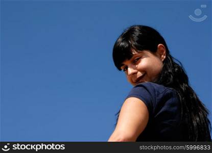 young woman with the sky as background