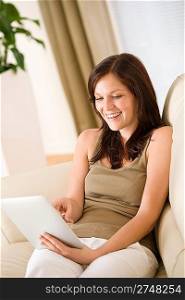 Young woman with touch screen tablet computer in lounge
