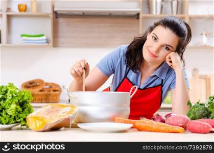 Young woman with vegetables in the kitchen 