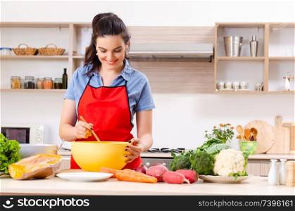 Young woman with vegetables in the kitchen