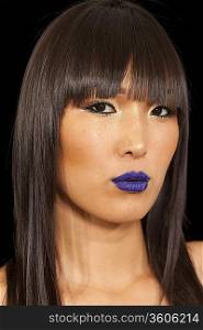 Young woman with vibrant blue lipstick