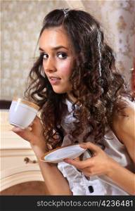Young woman with white cup of hot drink