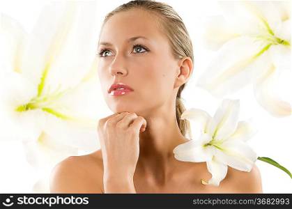 young woman with white lily on her shoulder looking up with eyes