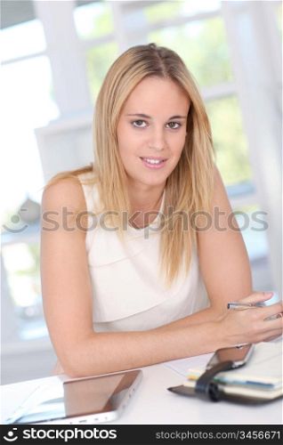 Young woman working at home with electronic tablet
