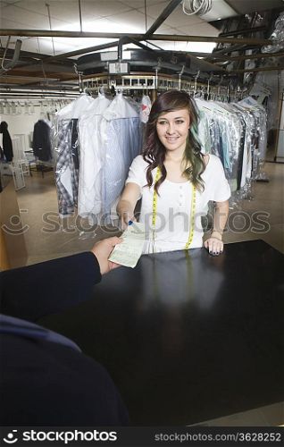 Young woman working in laundrette