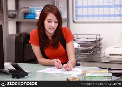 Young woman working in the office of a building firm