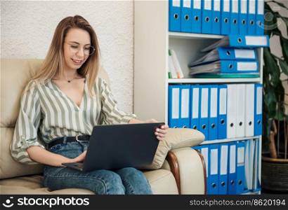 Young woman working on a computer in her office