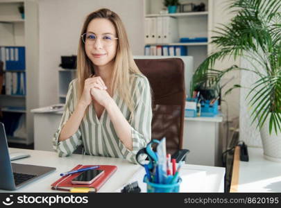 Young woman working on a computer in her office