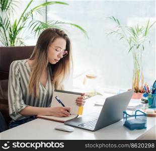 Young woman working on a computer in her office