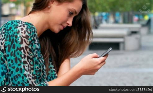 Young woman working on a mobile device.