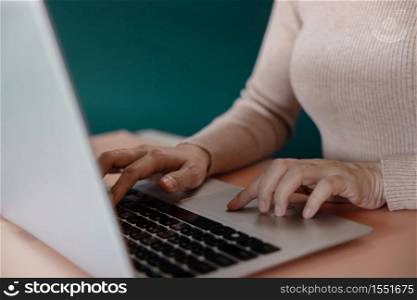 Young Woman Working on Computer Laptop. Closeup shot and Cropped Image
