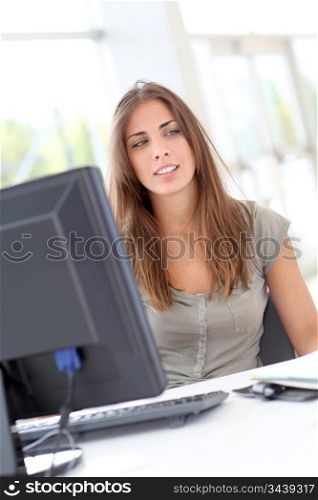 Young woman working on desktop computer