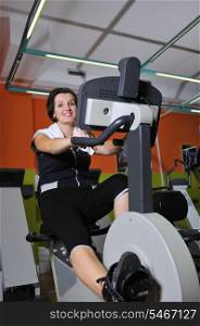 Young woman working out in fitness