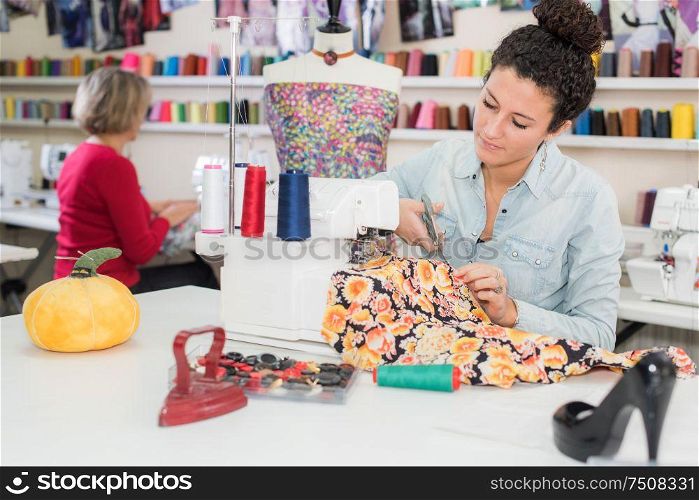 young woman working sewing machine