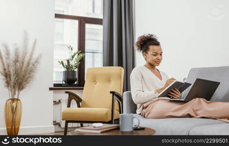 young woman working while sitting sofa