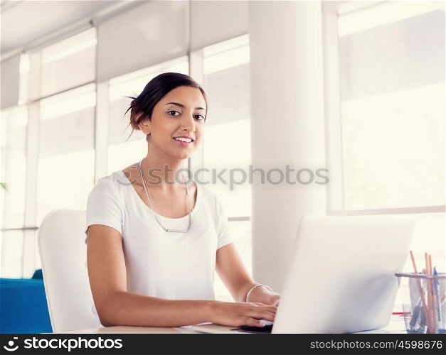 Young woman working with a laptop in office
