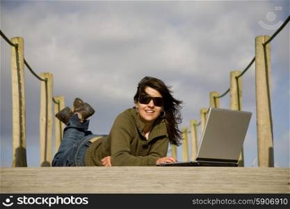 young woman working with computer at the beach