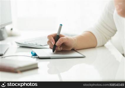 Young woman working with digital graphic tablet