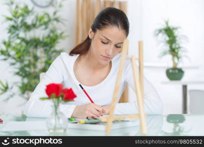 young woman writing at the table
