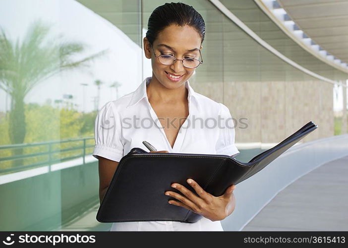 Young Woman Writing in a Planner