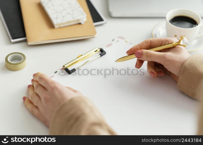 young woman writing notes clipboard
