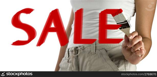 Young womans hand holding a brush painting a red sale sign on glass isolated on white background with copy space.