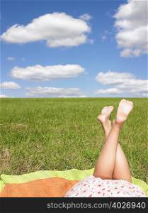 young womans legs in field