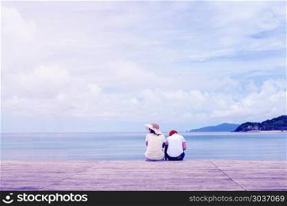 Young womans sitting on wooden pier. Travel concept.. Young woman sitting on wooden pier. Travel concept.