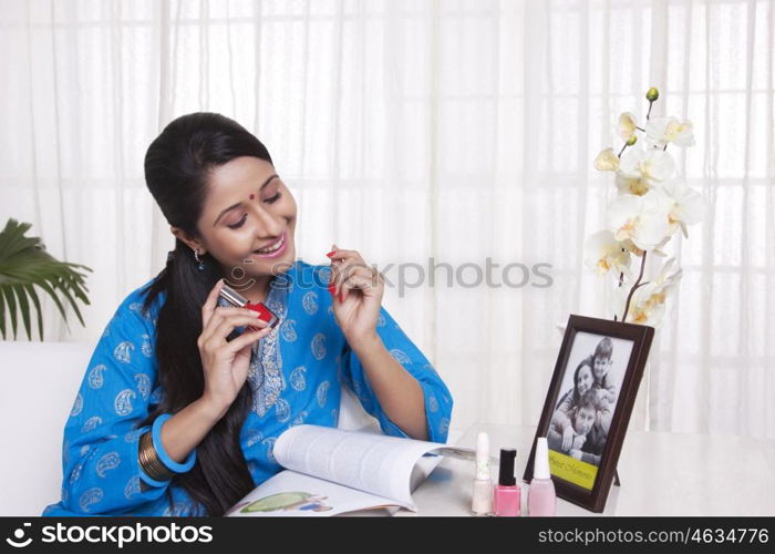 Young WOMEN applying nail polish