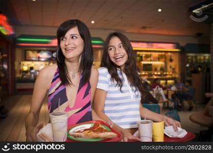 Young women at a shopping mall food court